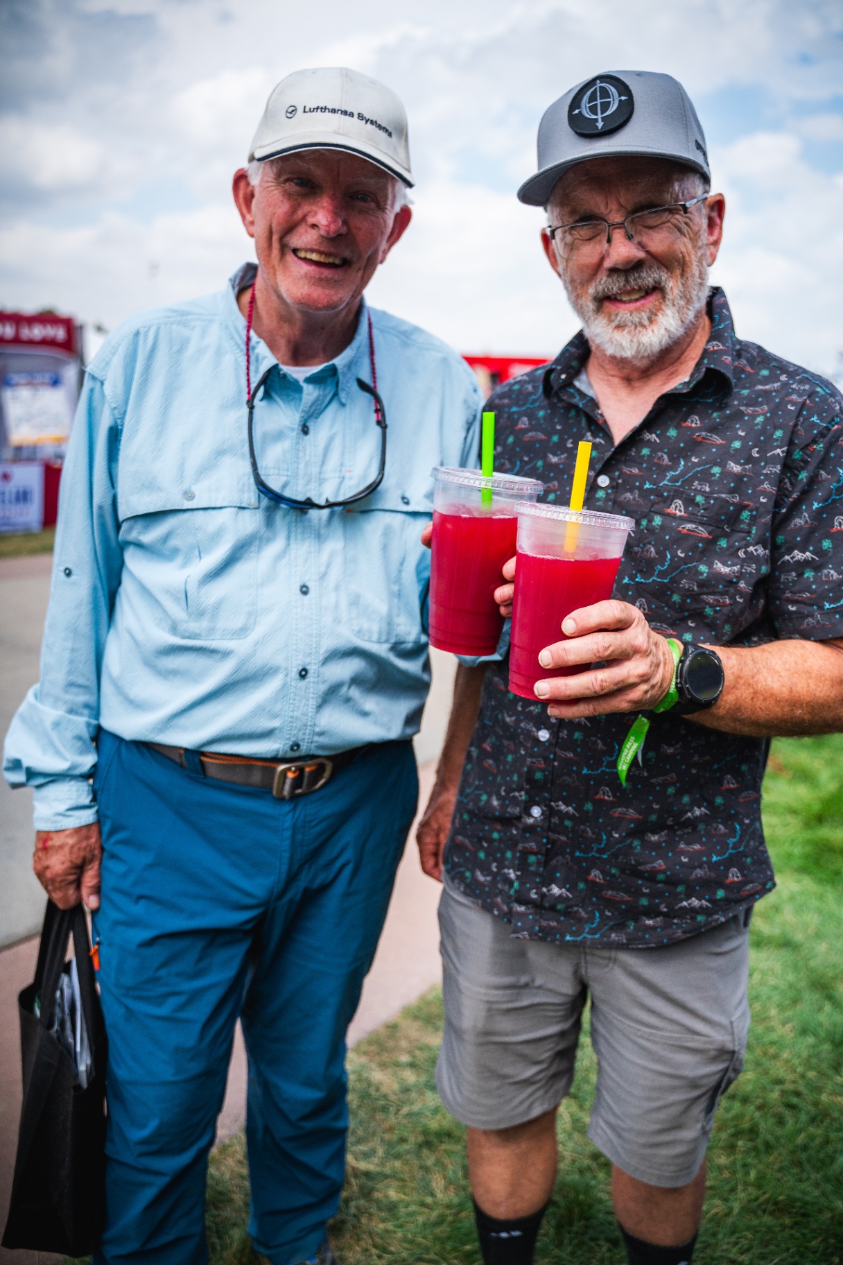 Two happy festival guests holding Southern Soul blackberry lemonades
